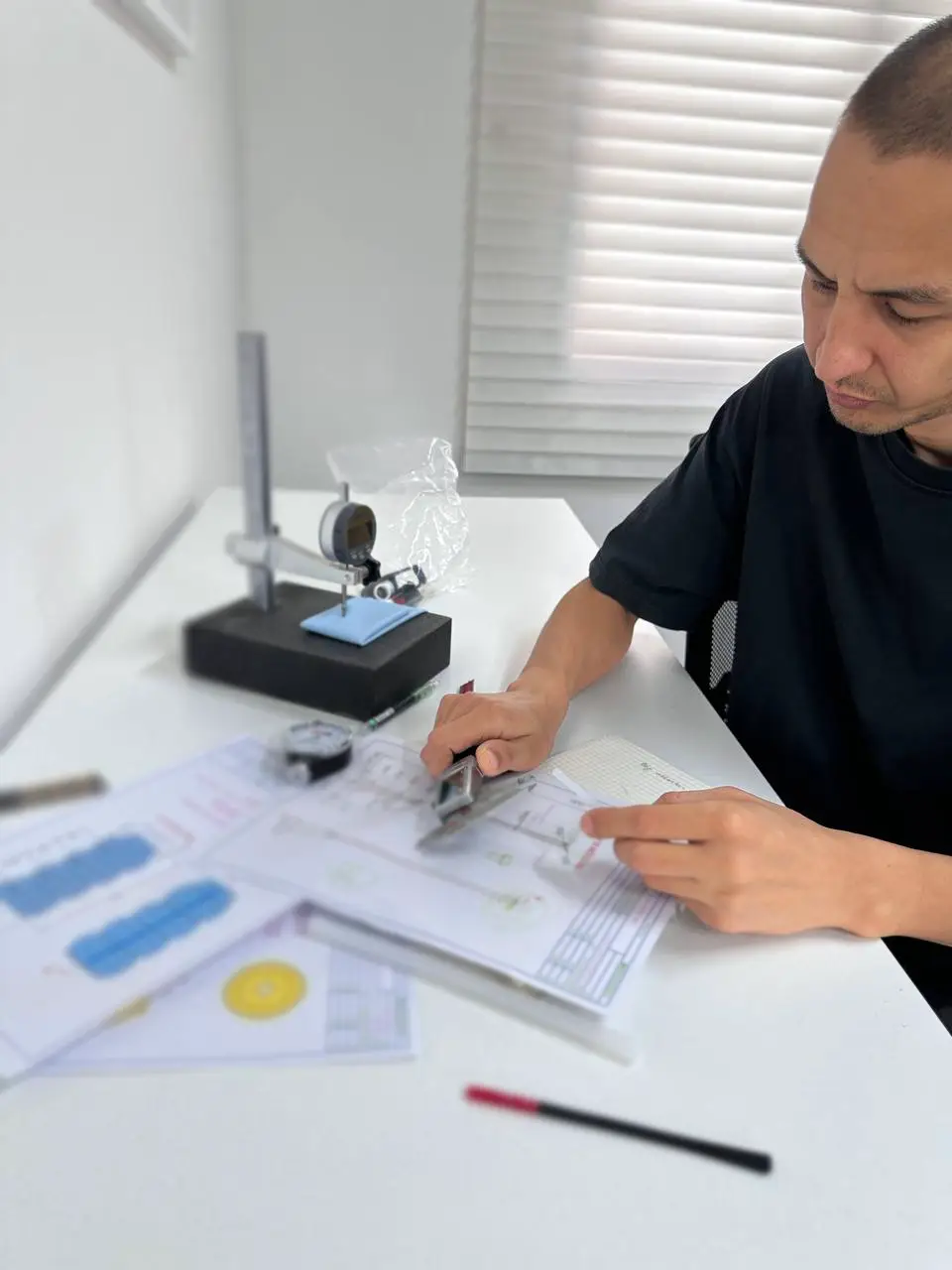 Dabojin engineer reviewing technical drawings and dimensional inspection reports