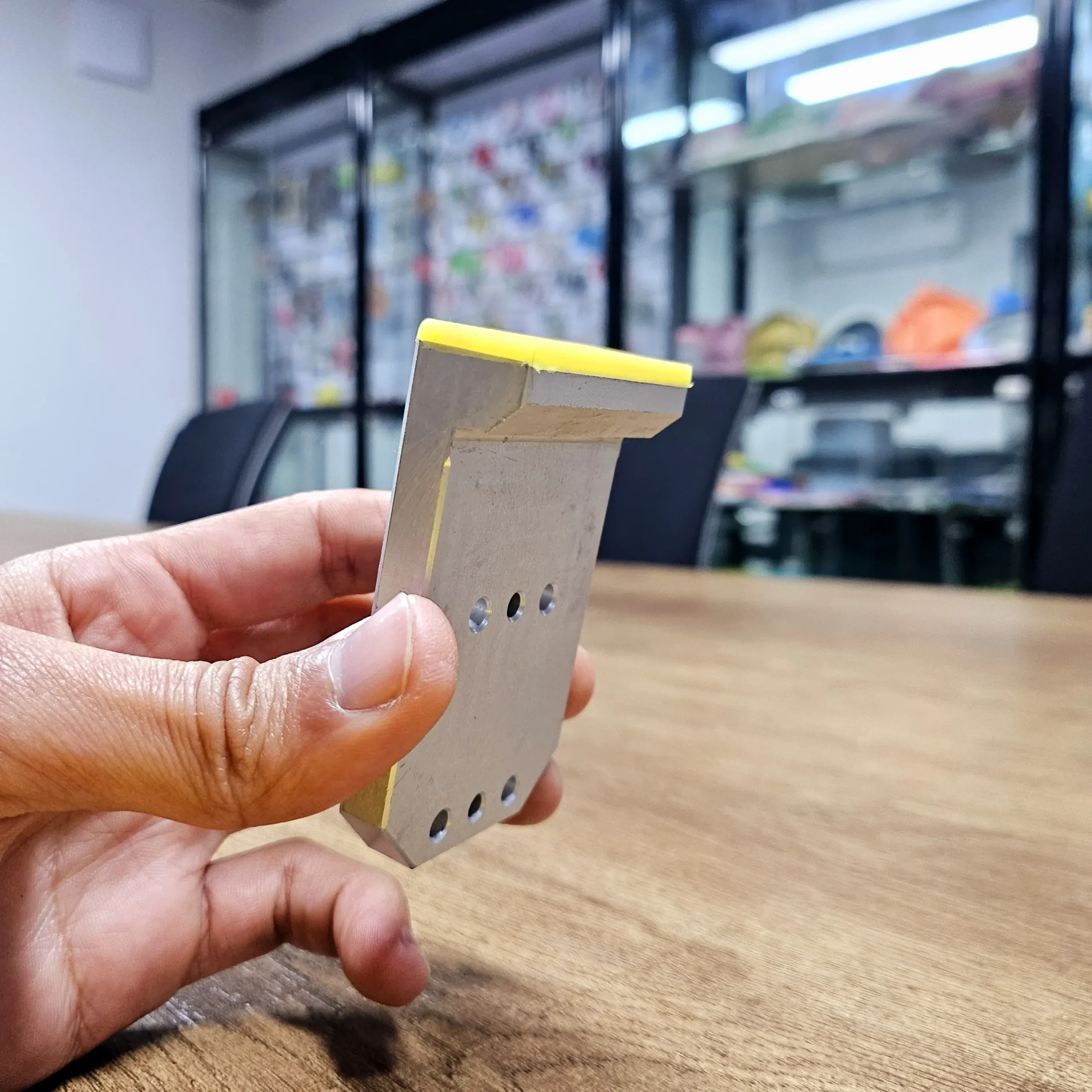 Aluminum bracket with silicone overmolded inserts