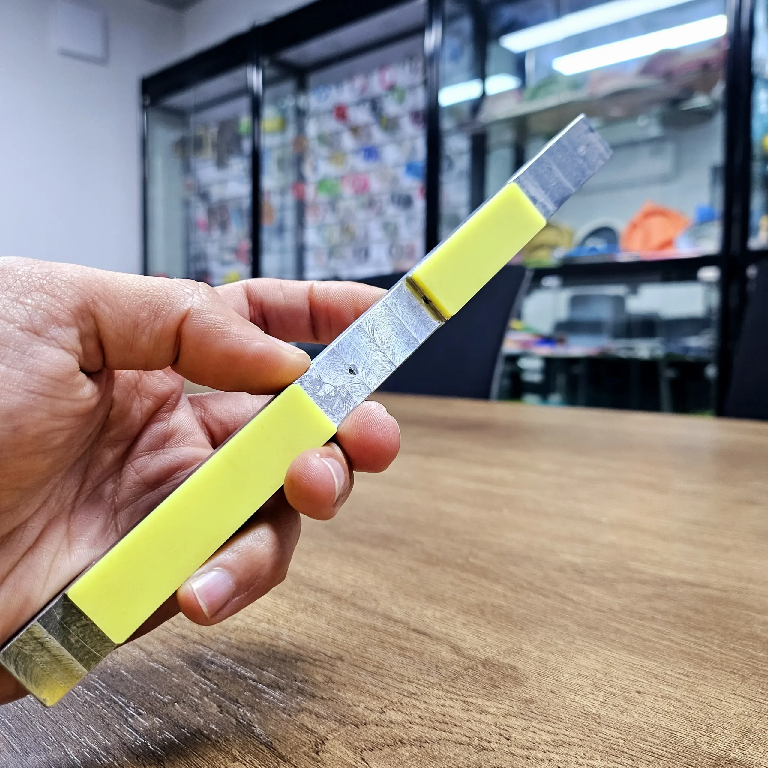 Yellow silicone end caps overmolded onto aluminium linear extrusion bracket ends