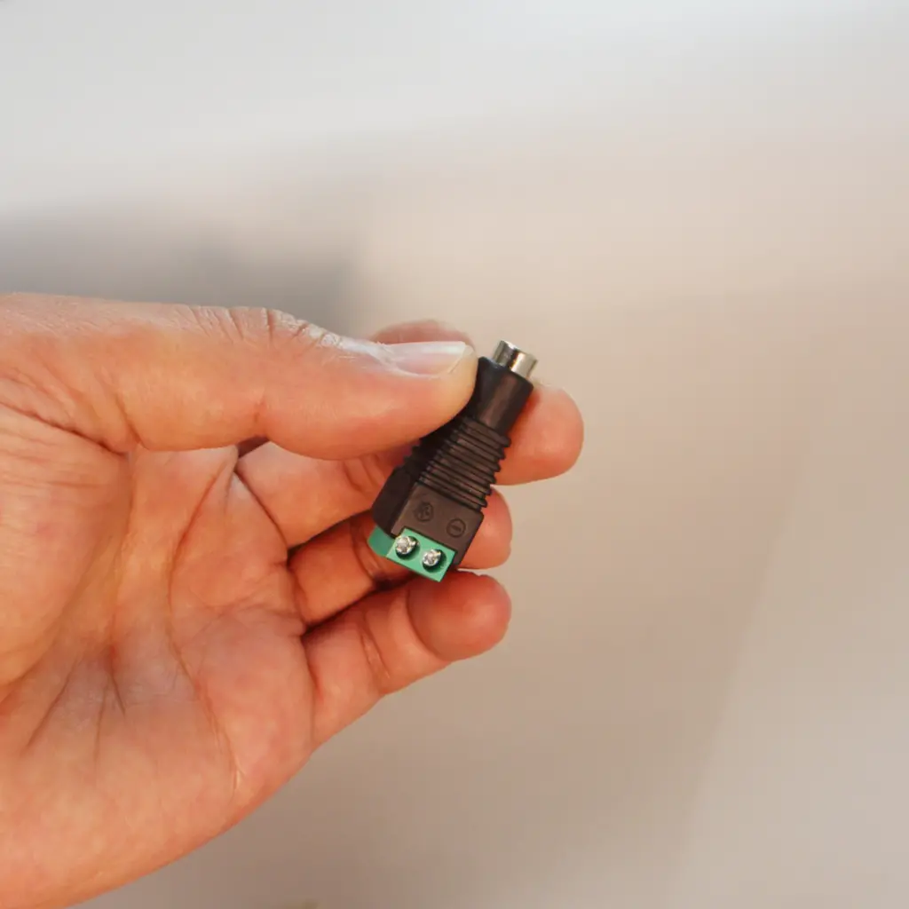 Black silicone overmolded onto DC barrel connector with cable boot and screw terminal