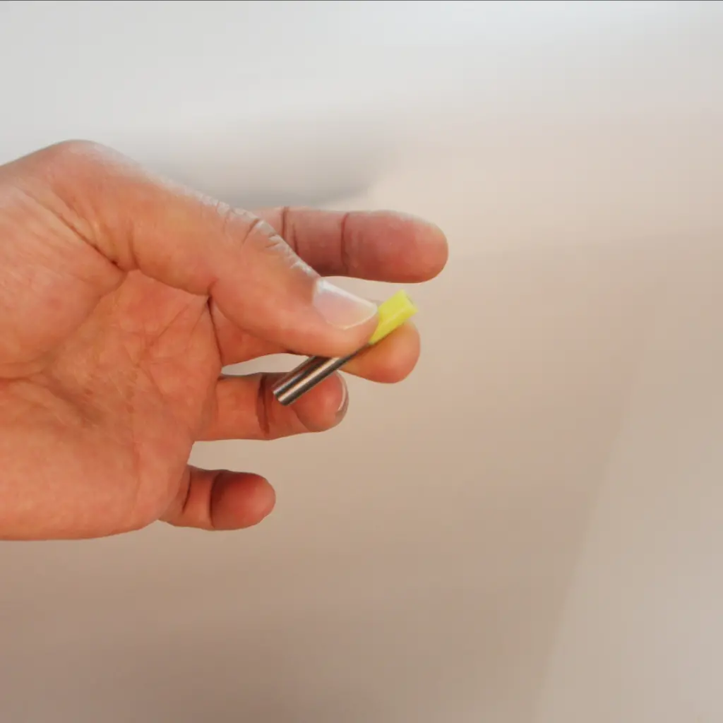 Small yellow silicone tip overmolded onto the end of a metal pin